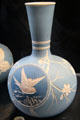 Salopian bottle vase incised with bird in flight in roundel on dark blue background by Benthall Pottery at Jackfield Tile Museum. Ironbridge, England.