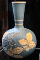 Salopian bottle vase incised with bird & bramble on light blue background by Benthall Pottery at Jackfield Tile Museum. Ironbridge, England.