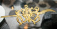 Gold ear pick with dog motif recovered from Spanish ship wreck off Florida at Historical Museum of Southern Florida. Miami, FL.