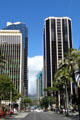 Black Pauahi Tower of Bishop Square on right over Bishop Street. Honolulu, HI.