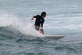 Standing surfers off Waikiki Beach. Waikiki, HI.