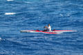 Paddling one-man outrigger off Waikiki Beach. Waikiki, HI.