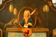 Symbolic detail of wolf devouring lamb of stock fiasco on "Mississippi Bubble" table at Cabildo Museum. New Orleans, LA.