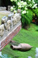 Antique sculpture & objects displayed in courtyard garden of Gardner Museum. Boston, MA.
