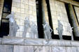 Cutout people sculpture set off by marble of Legislative Office Building. Albany, NY.