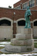 Bronze sculpture of Mark Twain stands on steps listing his books at Elmira College. Elmira, NY.