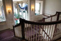 Intricately carved rails of main staircase which overlooks conservatory at Eastman House. Rochester, NY.