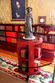 Circular book stand & statue of classical goddess in East Room at Eastman House. Rochester, NY.