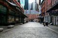 Front Street streetscape of South Street Seaport with Schermerhorn Row at end. New York, NY.