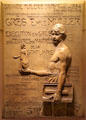 Boy with a tile glazed stoneware advertising relief for Muller Stoneware manufactory by Alexandre Charpentier at Metropolitan Museum of Art. New York, NY.