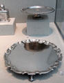Silver salvers rear by John Coney of Boston & front by Simeon Soumaine of New York City at Metropolitan Museum of Art. New York, NY.