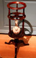 Wash basin stand on tripod with cutouts for soap dishes & lower shelf for water bottle from Newport, RI at Metropolitan Museum of Art. New York, NY.