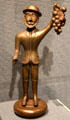 Sculpted wooden man with grapes tavern sign at Brooklyn Museum. Brooklyn, NY.