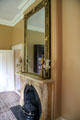 Marble fireplace in library with mirror & Argand lamps at Lindenwald. Kinderhook, NY.