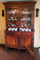 Glass fronted kitchen cabinet at Home Sweet Home Museum. East Hampton, NY.