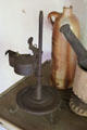 Betty oil lamp on adjustable height stand at Thomas Halsey Homestead. South Hampton, NY.