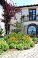 Courtyard garden with gate looking out to sea at Vanderbilt Mansion. Centerport, NY.