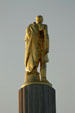Rear of The Pioneer gilded statue atop Oregon State Capitol. Salem, OR.
